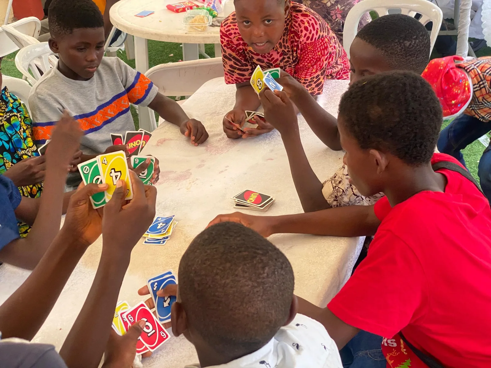 Children seated together with refreshments at a table.